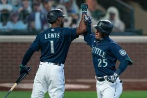 Seattle Mariners' Dylan Moore, right, is congratulated by teammate Kyle Lewis after hitting a solo home run off of Texas Rangers starting pitcher Kolby Allard during the third inning of a baseball game, Monday, Sept. 7, 2020, in Seattle. (AP Photo/Stephen Brashear)