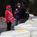 Farmer Frog founder Zsofia Pasztor and daughter Szabi Pastor chat with local Culturas Unidas Food Network driver and volunteer Fransisco Ramales on Friday in Woodinville. (Olivia Vanni / The Herald)