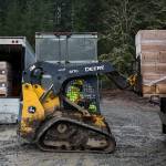 Farmer Frog staff loads food boxes into the back of a truck Friday in Woodinville. (Olivia Vanni / The Herald)