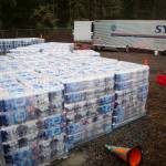 Pallets of water that will be shipped to tribes in Alaska sit on the property Friday in Woodinville. (Olivia Vanni / The Herald)
