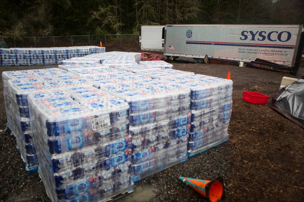 Pallets of water that will be shipped to tribes in Alaska sit on the property Friday in Woodinville. (Olivia Vanni / The Herald)