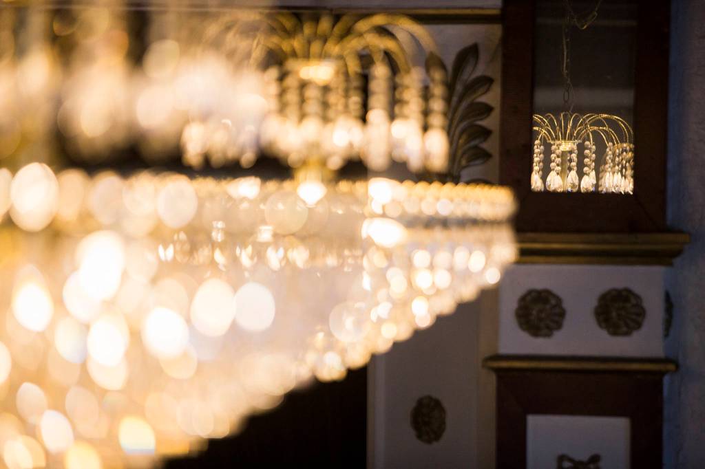 Chandeliers hang from the ceiling that was restored to match the original at the Marysville Opera House. (Olivia Vanni / The Herald)