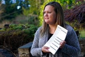Rep. Tarra Simmons, D-Bremerton, holds blank voter registration forms as she poses for a photo Wednesday, Dec. 9, 2020, at her home in Bremerton, Wash. Simmons, believed to be the first formerly incarcerated person to win election to the Statehouse, is now working to help restore voting rights to people in Washington state who are out on parole or probation after serving prison time. (AP Photo/Ted S. Warren)
