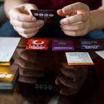 Jonathan Noble pulls a card from the deck as he demonstrates how to play through 2020: The Game. (Olivia Vanni / The Herald)