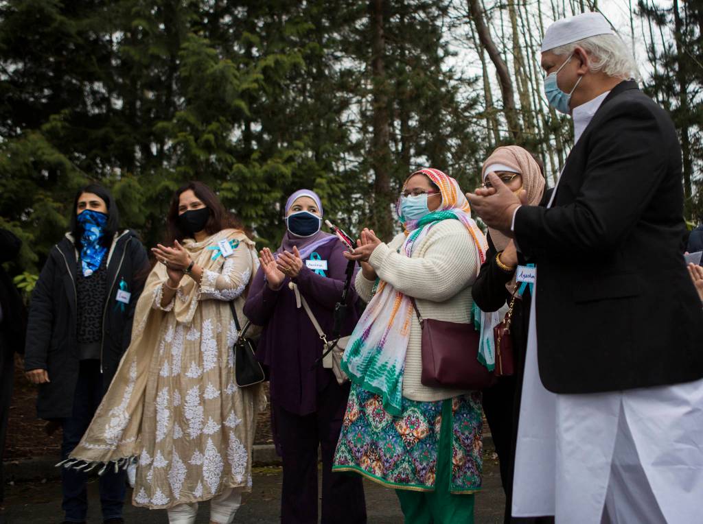 Board members applaud at the groundbreaking for the Islamic Center of Mukilteo on Saturday. (Olivia Vanni / The Herald)