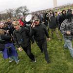 In this Jan. 6 photo, Ethan Nordean, with backward baseball hat and bullhorn, leads members of the far-right group Proud Boys in marching before the riot at the U.S. Capitol. (AP Photo/Carolyn Kaster, File)