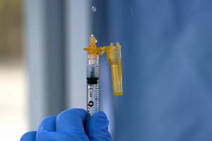A syringe of the Moderna COVID-19 vaccine is shown Thursday, March 4, 2021, at a drive-up mass vaccination site in Puyallup, Wash., south of Seattle. Officials said they expected to deliver approximately 2500 second doses of the Moderna COVID-19 vaccine at the site Thursday. (AP Photo/Ted S. Warren)