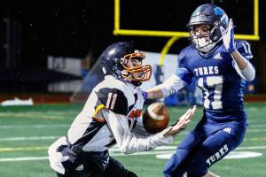 Granite Falls' Riley Hoople makes a reception with Sultan's Derek Feltner defending Friday night in Sultan on February 26, 2021 (Kevin Clark / The Herald)