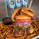 Scuttlebutt Brewing Co. chef Jeremiah Marleau created the Triple Threat burger, made of two patties, pulled pork, three onion rings and a lot of heat. If you can eat it in 25 minutes, its on the house. (Andy Bronson / The Herald)