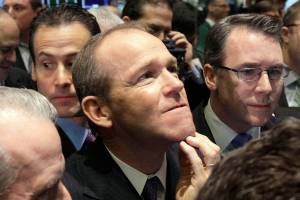 FILE - In this Jan. 26, 2011 file photo, Nielsen Company CEO David Calhoun, center, watches progress as he waits for the company's IPO to begin trading, on the floor of the New York Stock Exchange. Boeing CEO David Calhoun declined a salary and performance bonus for most of 2020 but still received stock benefits that pushed the estimated value of his compensation to more than $21 million, according to a regulatory filing Friday, March 5, 2021. (AP Photo/Richard Drew, File)