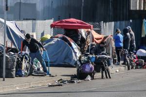 People experiencing homelessness camping on Smith Avenue Thursday afternoon in Everett on March 11, 2021. (Kevin Clark / The Herald)