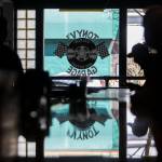 The new Tony Vs Garage window logo is reflected off the newly installed bartop in Everett. (Olivia Vanni / The Herald)