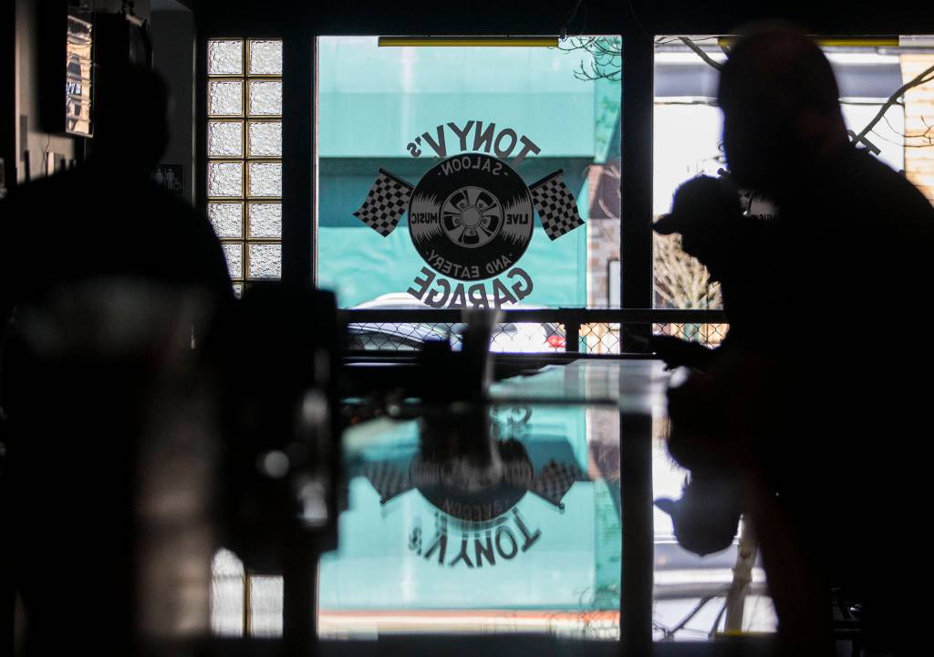 The new Tony Vs Garage window logo is reflected off the newly installed bartop in Everett. (Olivia Vanni / The Herald)