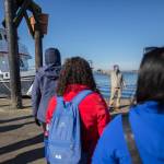 Capt. Carl Williams speaks to a socially distanced and masked group of whale watchers before boarding the Island Explorer 4 in Everett. (Olivia Vanni / The Herald)