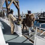 People board the Island Explorer 4 in Everett. Island Adventures Whale Watching is back in operation after closing for several months last year due to the coronavirus pandemic. (Olivia Vanni / The Herald)