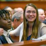 Plaintiffs Kelsey Juliana (right) and Vic Barrett (left) gather with other youth plaintiffs in the Juliana v. United States climate change lawsuit in a federal courthouse for a hearing in front of a panel of judges with the 9th Circuit Court of Appeals in Portland on June 4, 2019. (Robin Loznak/Pool Photo via AP, file)