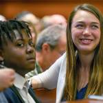 Plaintiffs Kelsey Juliana, right and Vic Barrett, left, gather with other youth plaintiffs in the Juliana v. United States climate change lawsuit in a federal courthouse for a hearing in front of a panel of judges with the 9th Circuit Court of Appeals in Portland on Tuesday, June 4, 2019. The lawsuit by a group of young people who say U.S. energy policies are causing climate change and hurting their future faces a major hurdle Tuesday as lawyers for the Trump administration argue to stop the case from moving forward. (Robin Loznak/Pool Photo via AP)