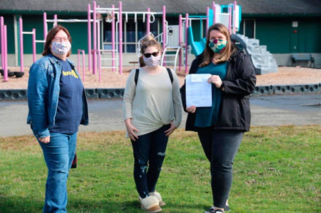 Laurie Westover, former president of the Lake Stevens Rotary Club, presents a check for $14,500 for the playground project to Tanya Murray, Playground Committee Chair and Nicole Beck, Treasurer of the Highland Elementary School PTA.