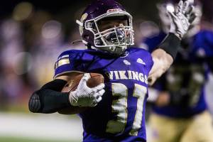 Lake Stevens' Jay Roughton raises his arms as he runs in the ball for a touchdown during the game against Archbishop Murphy on Saturday, March 6, 2021 in Lake Stevens, Wa. (Olivia Vanni / The Herald)
