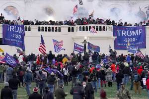FILE - In this Wednesday, Jan. 6, 2021, file photo, rioters storm the Capitol, in Washington. Capitol Police say they have intelligence showing a “possible plot” by a militia group to breach the U.S. Capitol on Thursday, nearly two months after a mob of supporters of then-President Donald Trump stormed the iconic building to try to stop Congress from certifying now-President Joe Biden's victory.  The threat appears to be connected to a far-right conspiracy theory, mainly promoted by supporters of QAnon, that Trump will rise again to power on March 4. That was the original presidential inauguration day until 1933, when it was moved to Jan. 20.  (AP Photo/John Minchillo, File)