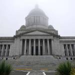 FILE - In this Jan. 7, 2021, file photo, the Legislative Building is shown partially shrouded in fog at the Capitol in Olympia, Wash. Washington state's richest residents, including Bill Gates and Jeff Bezos, would pay a wealth tax on certain financial assets worth more than $1 billion under a proposed bill whose sponsor says she is seeking a fair and equitable tax code. Under the bill, starting Jan. 1, 2022, for taxes due in 2023, a 1% tax would be levied not on income, but on "extraordinary" assets ranging from cash, publicly traded options, futures contracts, and stocks and bonds. (AP Photo/Ted S. Warren, File)