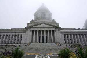 FILE - In this Jan. 7, 2021, file photo, the Legislative Building is shown partially shrouded in fog at the Capitol in Olympia, Wash. Washington state's richest residents, including Bill Gates and Jeff Bezos, would pay a wealth tax on certain financial assets worth more than $1 billion under a proposed bill whose sponsor says she is seeking a fair and equitable tax code. Under the bill, starting Jan. 1, 2022, for taxes due in 2023, a 1% tax would be levied not on income, but on "extraordinary" assets ranging from cash, publicly traded options, futures contracts, and stocks and bonds. (AP Photo/Ted S. Warren, File)