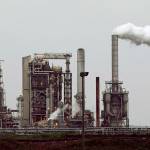 ADDS THAT THE REFINERY'S CURRENT OWNER IS ANDEAVOR - FILE - This April 2, 2010 file photo shows a refinery owned by Andeavor, formerly Tesoro Corp. including a gas flare flame that is part of normal plant operations, in Anacortes, Wash. A campaign bankrolled by the oil industry has raised $20.46 million to defeat a carbon pollution fee on the ballot in Washington state aiming at tackling climate change. (AP Photo/Ted S. Warren, File)