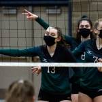 Jacksons Ainsley Johanson (left-right), Erin Ingram and Ellina Powell await the serve during a match against Arlington on Thursday night at Arlington High School. (Kevin Clark / The Herald)
