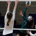 Jacksons Brooklyn Coleman (right) hits with Arlingtons Malia Shepherd defending Thursday night at Arlington High on March 11, 2021. (Kevin Clark / The Herald)