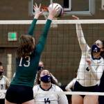 Jacksons Ainsley Johanson attempts a block on Arlingtons Cassie Whitaker Thursday night at Arlington High on March 11, 2021. (Kevin Clark / The Herald)