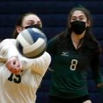 Jacksons Rosa Ursino dips with Erin Ingram (right) against Arlington Thursday night at Arlington High on March 11, 2021. (Kevin Clark / The Herald)