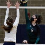 Jacksons Erin Ingram (right) spikes with Arlingtons Paige Richards defending Thursday night at Arlington High on March 11, 2021. (Kevin Clark / The Herald)