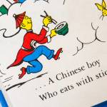 Two copies of the Dr. Seuss children's' book “And to Think That I Saw It on Mulberry Street” are displayed at the Lackawanna County Children's Library collection in Scranton, Pa., Tuesday, March 2, 2021, show changes between editions. An earlier 1964 edition features a character described as "a Chinese boy" with yellow skin and a long ponytail, while a 1984 edition changes the character to "a Chinese man" and removes the skintone and ponytail. Six Dr. Seuss books — including “And to Think That I Saw It on Mulberry Street” and “If I Ran the Zoo” — will stop being published because of racist and insensitive imagery, the business that preserves and protects the author's legacy said Tuesday.
 (Christopher Dolan/The Times-Tribune via AP)