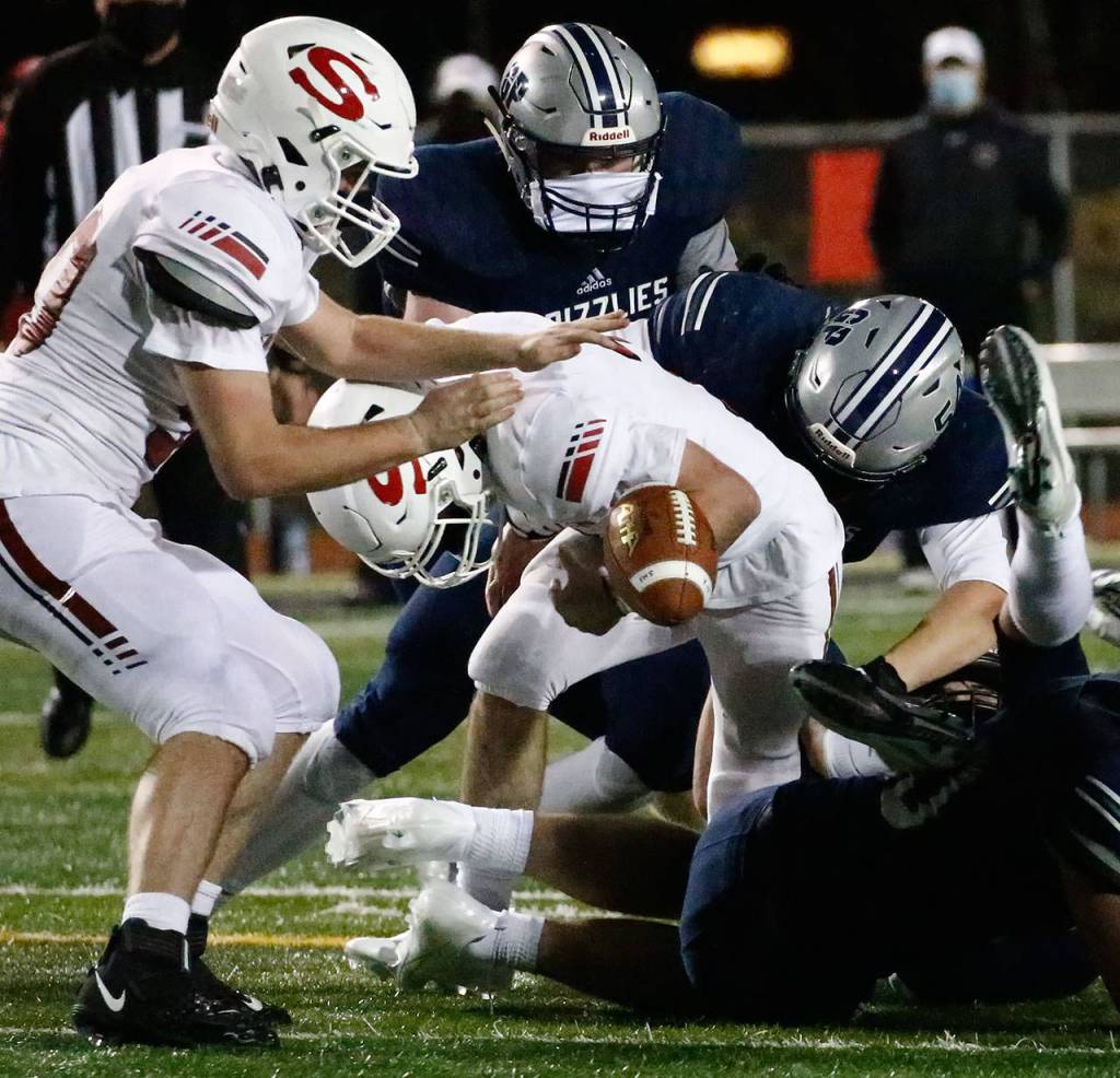 Snohomish's Ashton Olson fumbles the ball against Glacier Peak at Veterans Memorial Stadium Friday night in Snohomish on March 12, 2021. (Kevin Clark / The Herald)