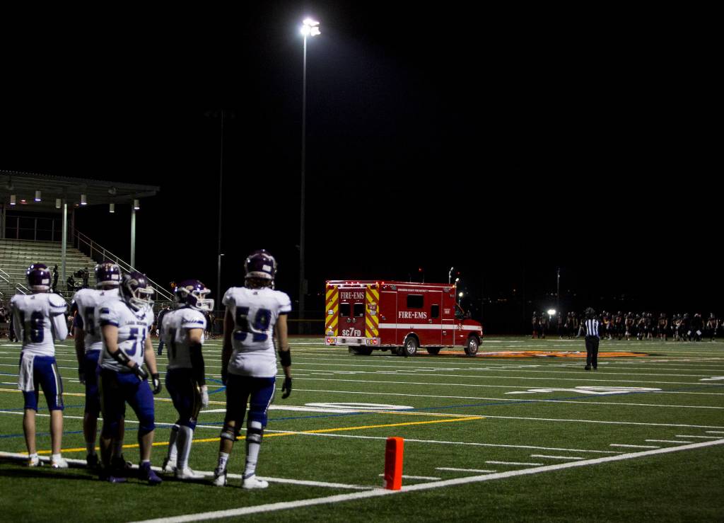 An ambulance makes its way off the field during the game between Lake Stevens and Monroe on Friday, March 12, 2021 in Monroe, Wa. (Olivia Vanni / The Herald)
