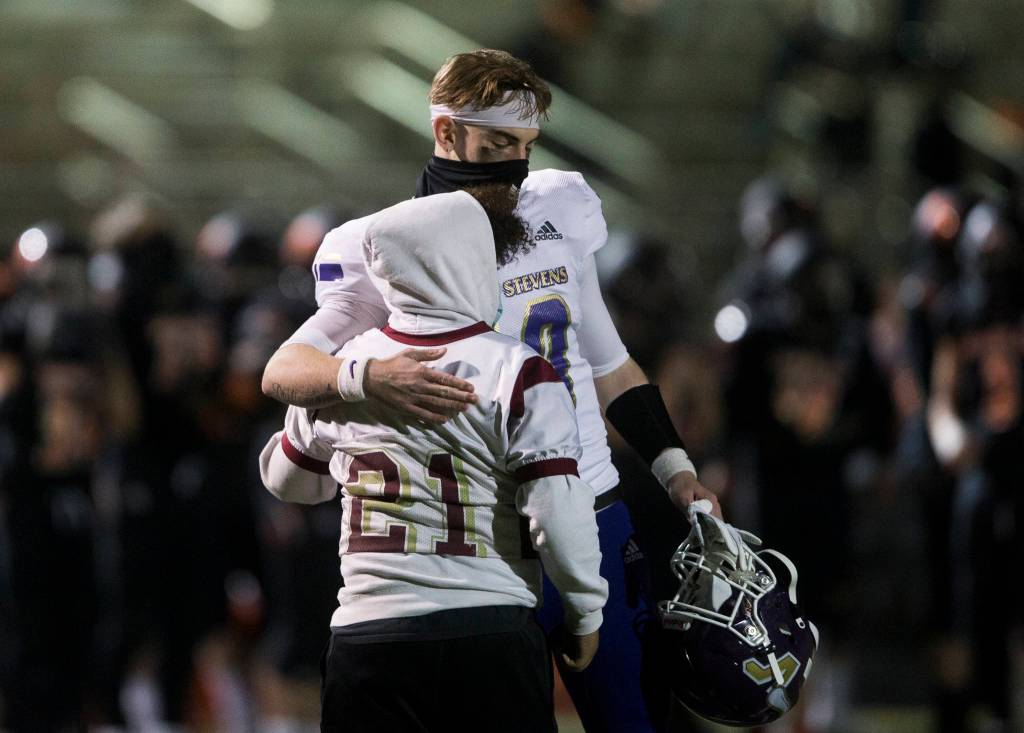 Lake Stevens players comfort Darquise Olesons brother during the game on Friday, March 12, 2021 in Monroe, Wa. (Olivia Vanni / The Herald)