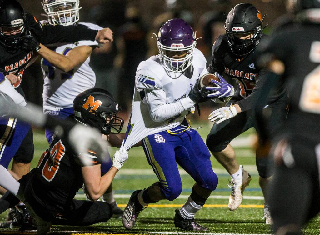 Lake Stevens Trayce Hanks runs through a tackle during the game against on Friday, March 12, 2021 in Monroe, Wa. (Olivia Vanni / The Herald)