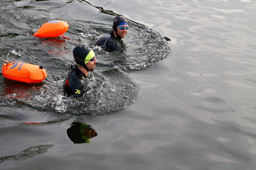 Travis Van Overbek (top) and Mark Albrecht swim in Lake Stevens on Saturday morning at Lundeen Park. (Kevin Clark / The Herald)