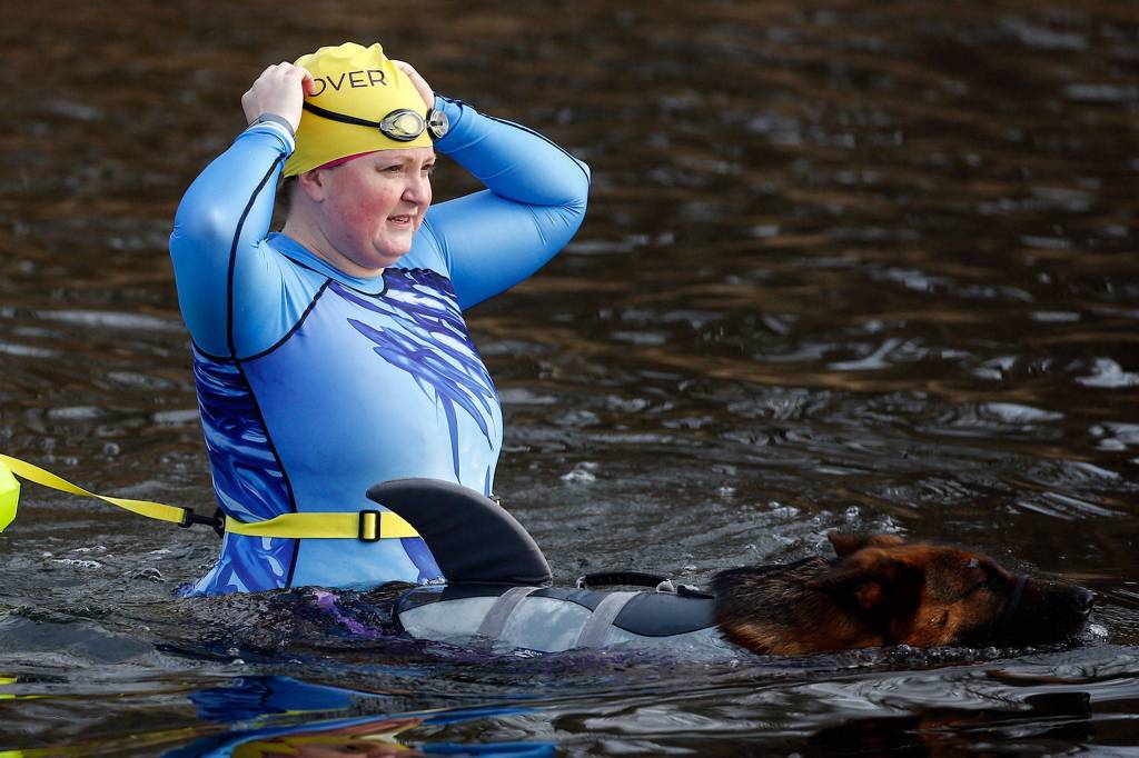 Danielle Jacobson wades into Lake Stevens on Saturday morning at Lundeen Park. (Kevin Clark / The Herald)