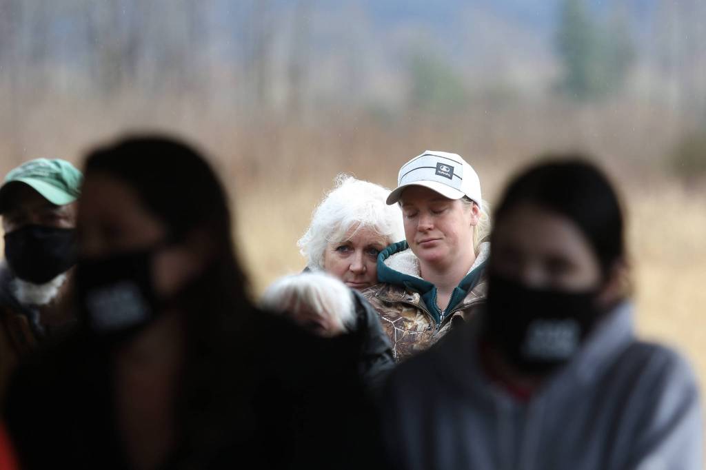 Diana Bejvl and her daughter, Lisa, hug as they listen to the names of family and friends killed in the 2014 Oso landslide. Bejvls son, Alan, and his fiance, Delaney Webb, were among those who died. (Andy Bronson / The Herald)
