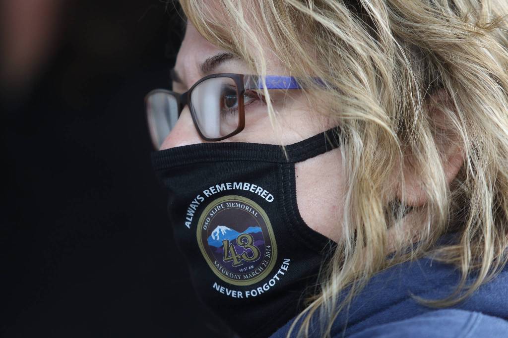 Amber Hall wears an Oso Memorial face mask during a seventh anniversary ceremony on Monday near Oso. (Andy Bronson / The Herald)