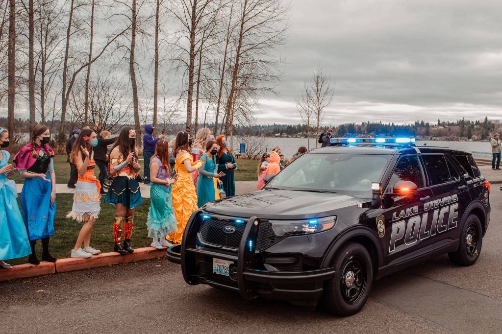 A police car drives through a fundraiser for Bethany Erickson and her family at Lundeen Park in Lake Stevens on March 6. (Stephanie Walls)
