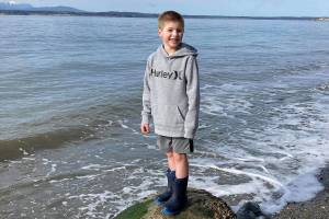 Blake Lewis, 7, at Bush Point where he threw a message in a bottle out to sea. Ruth Smethers later picked it up in Port Townsend. Photo provided by Jessie Lewis