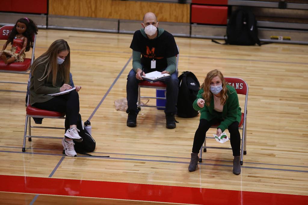 Monroe Head Coach Nicole Hayes, right, gives instructions to her players as Stanwood took on Monroe in a volleyball game on Wednesday, March 17, 2021 in Stanwood, Washington. (Andy Bronson / The Herald)