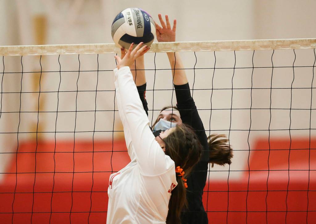 Stanwoods Mischa Kessler is blocked by Monroes Campbell Barrow as Stanwood took on Monroe in a volleyball game on Wednesday, March 17, 2021 in Stanwood, Washington. (Andy Bronson / The Herald)