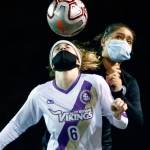 Lake Stevens Delaine Polly (front) heads the ball with Jacksons Maki Quiyono closing in during a match Thursday night at Memorial Stadium in Everet. (Kevin Clark / The Herald)