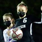 Jacksons Abigail McKay controls the ball with Lake Stevens Delaine Polly trailing Thursday night at Memorial Stadium in Everett on March 18, 2021. (Kevin Clark / The Herald)