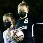 Jackson's Abigail McKay controls the ball with Lake Stevens' Delaine Polly trailing Thursday night at Memorial Stadium in Everett on March 18, 2021. (Kevin Clark / The Herald)
