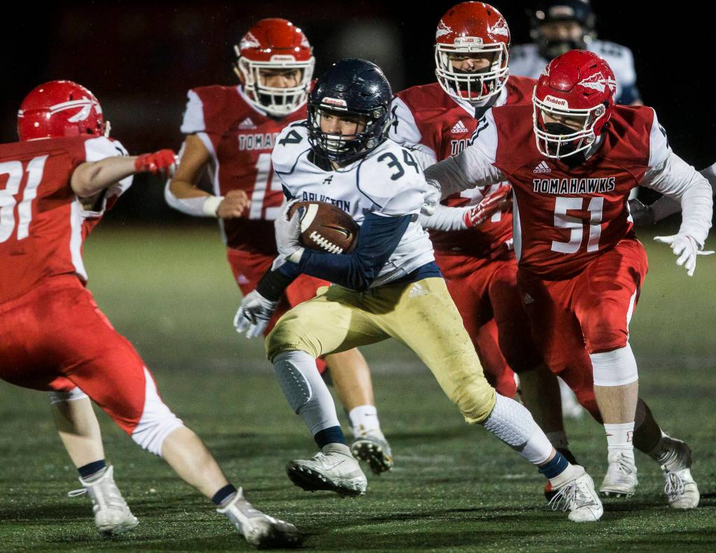 Marysville-Pilchucks defense chases down Arlingtons Spencer Fischer during the game on Friday, March 19, 2021 in Marysville, Wa. (Olivia Vanni / The Herald)