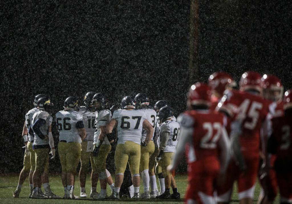 Marysville-Pilchuck and Arlington huddle for a timeout during the game on Friday, March 19, 2021 in Marysville, Wa. (Olivia Vanni / The Herald)